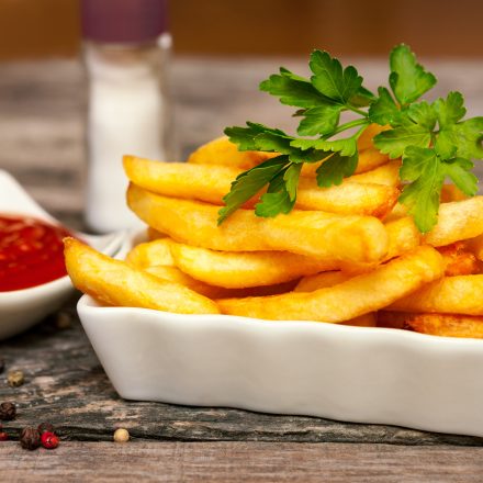 Close,Up,With,French,Fries,And,Small,Bowl,With,Parsley